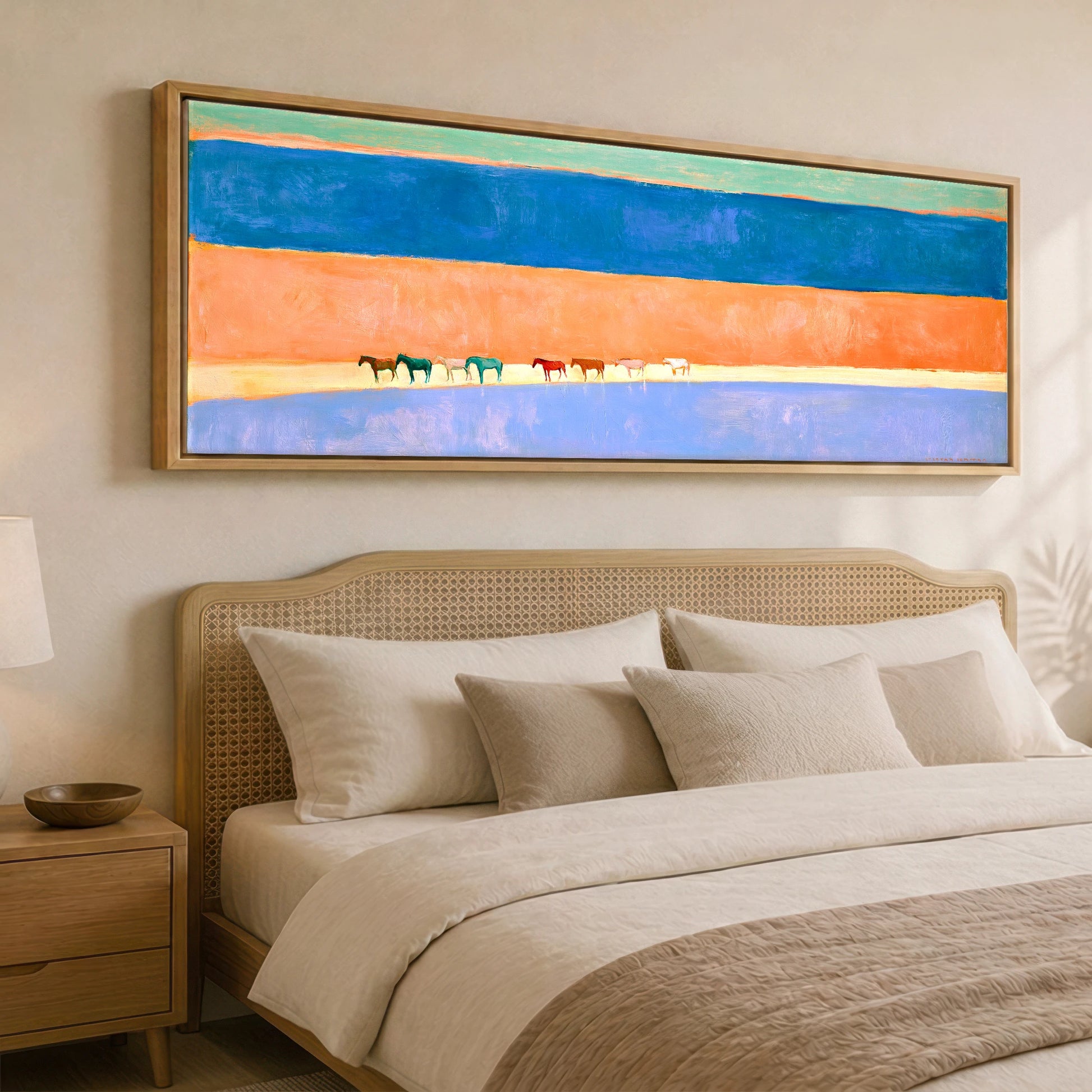 The Painted Horizon Wild Horses panoramic canvas wall art displayed above a bed