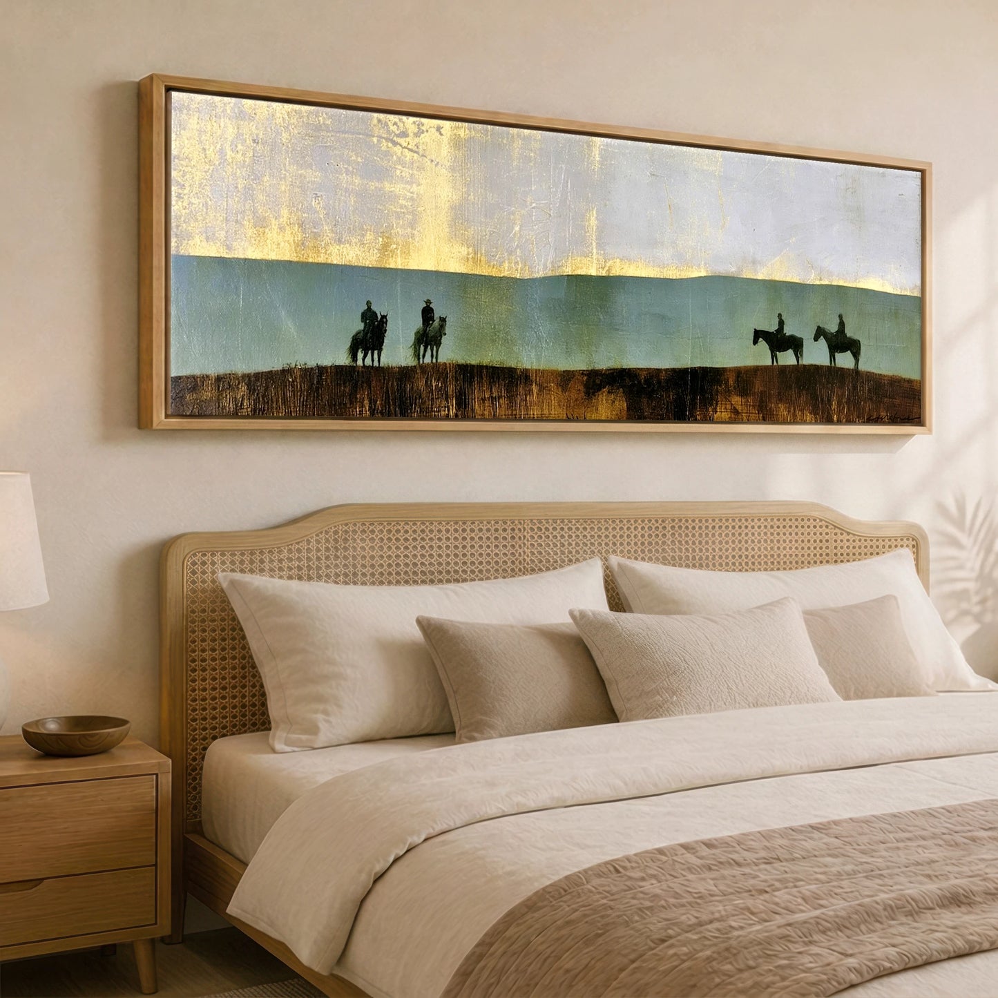 The Gilded Ridge Horse & Rider panoramic canvas wall art displayed above a bed