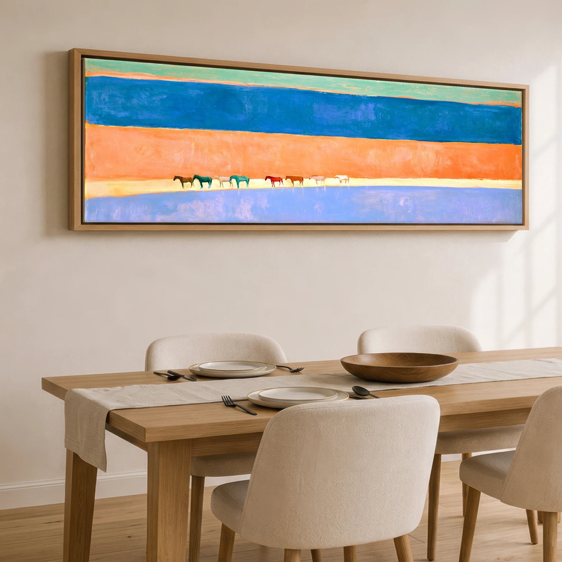 The Painted Horizon Wild Horses panoramic canvas wall art displayed above a dining table