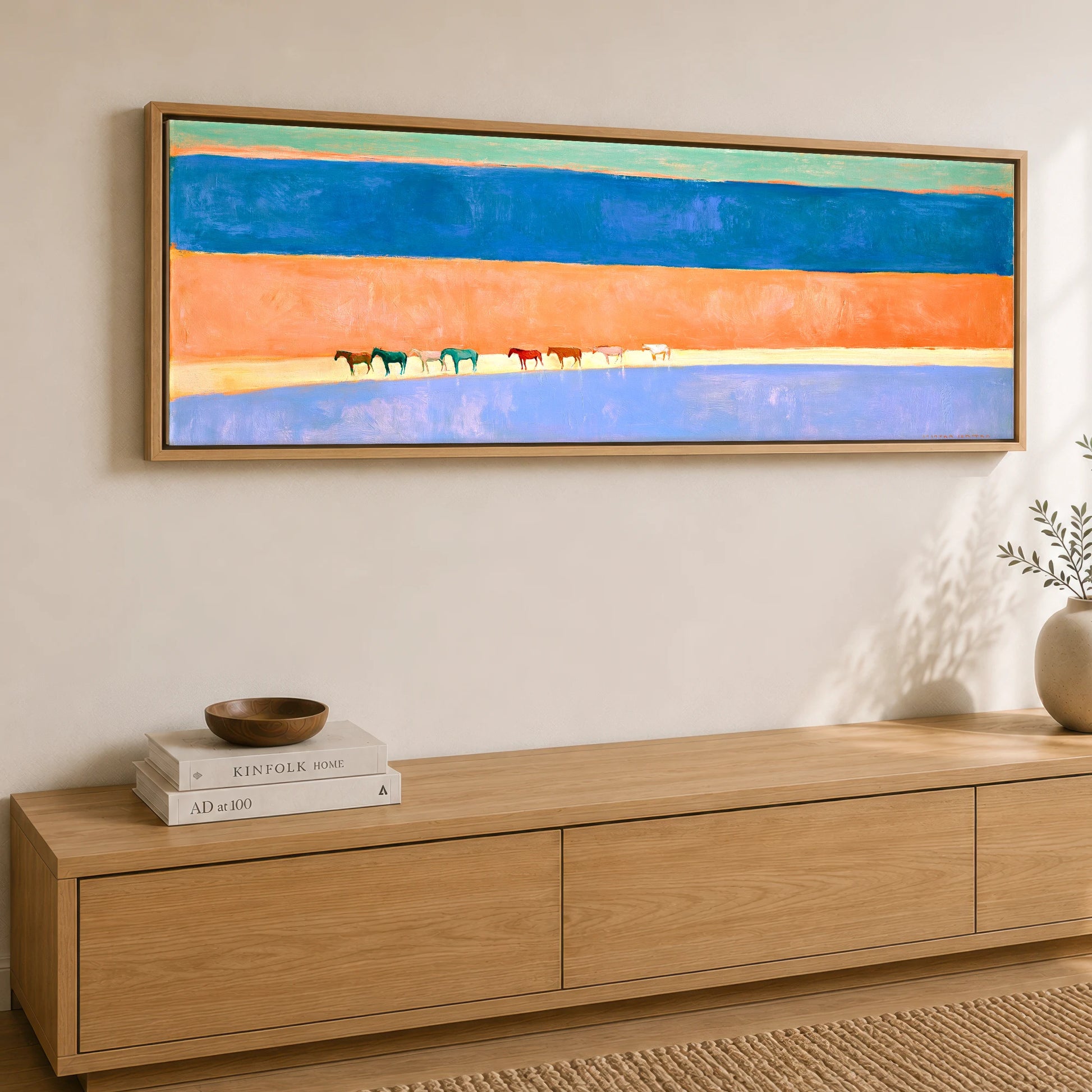 The Painted Horizon Wild Horses panoramic canvas wall art displayed above a sideboard
