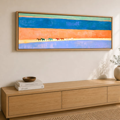 The Painted Horizon Wild Horses panoramic canvas wall art displayed above a sideboard