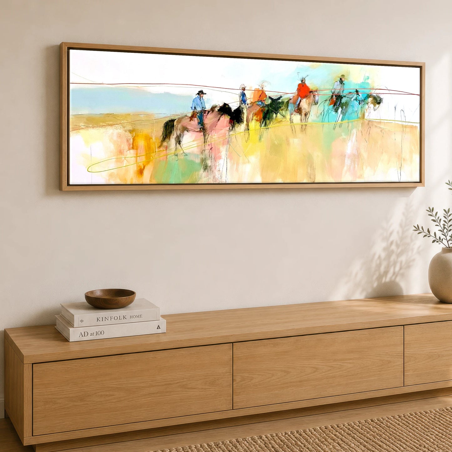 Across the High Plains Horse & Rider panoramic canvas wall art displayed above a sideboard