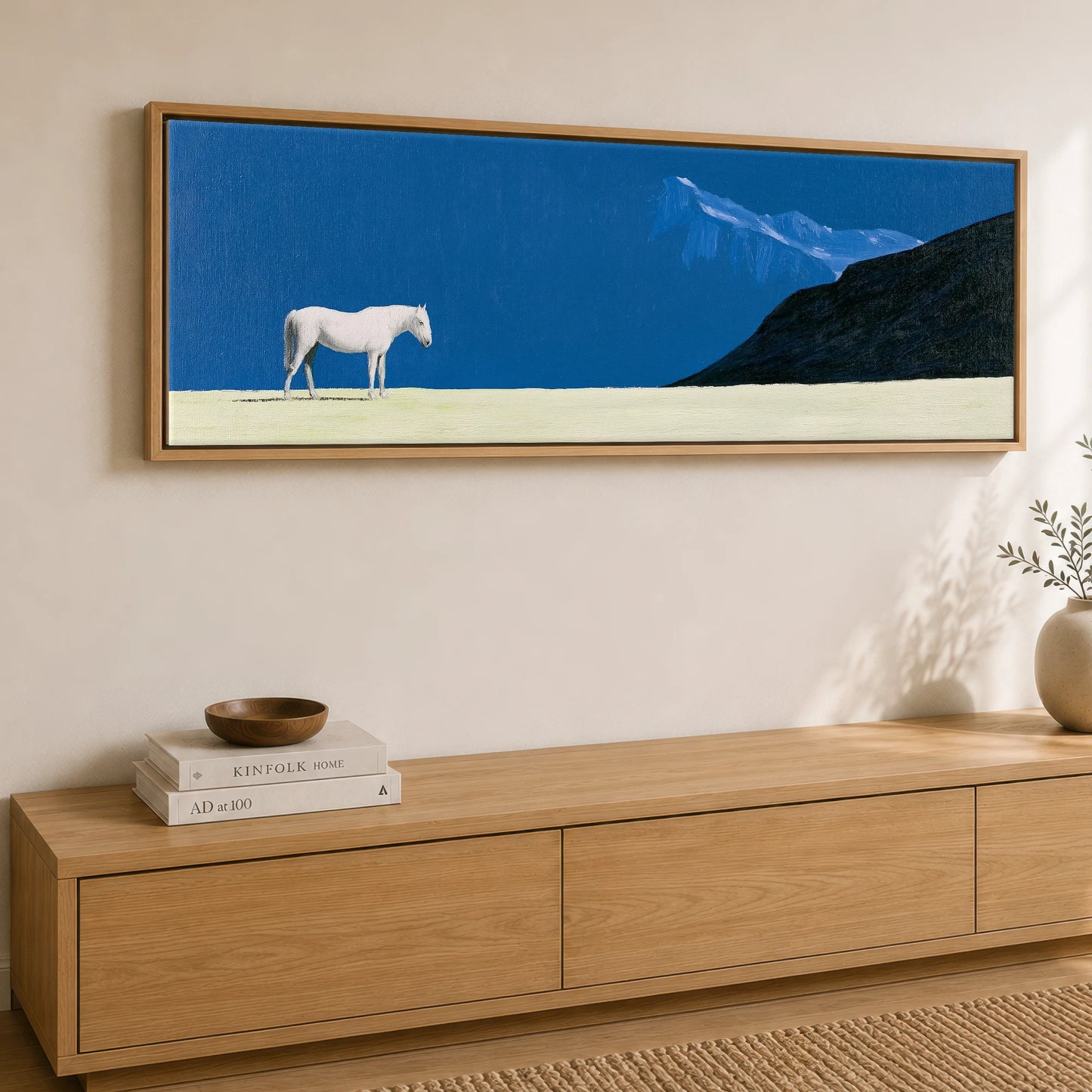 Solitude in Blue Horse Landscape panoramic canvas wall art displayed above a sideboard