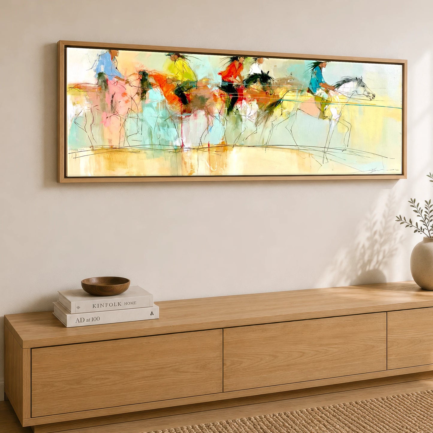 The Vibrant Canter Horse & Rider panoramic canvas wall art displayed above a sideboard