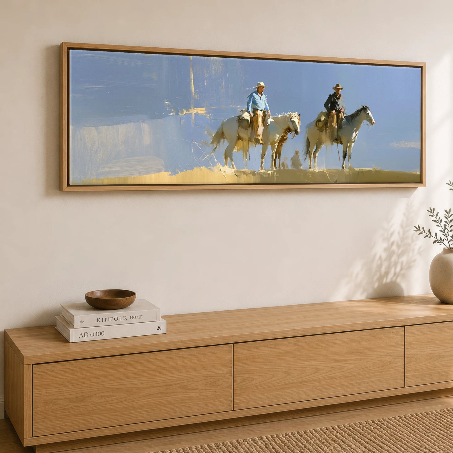 Sunlit Range Riders Horse & Rider panoramic canvas wall art displayed above a sideboard