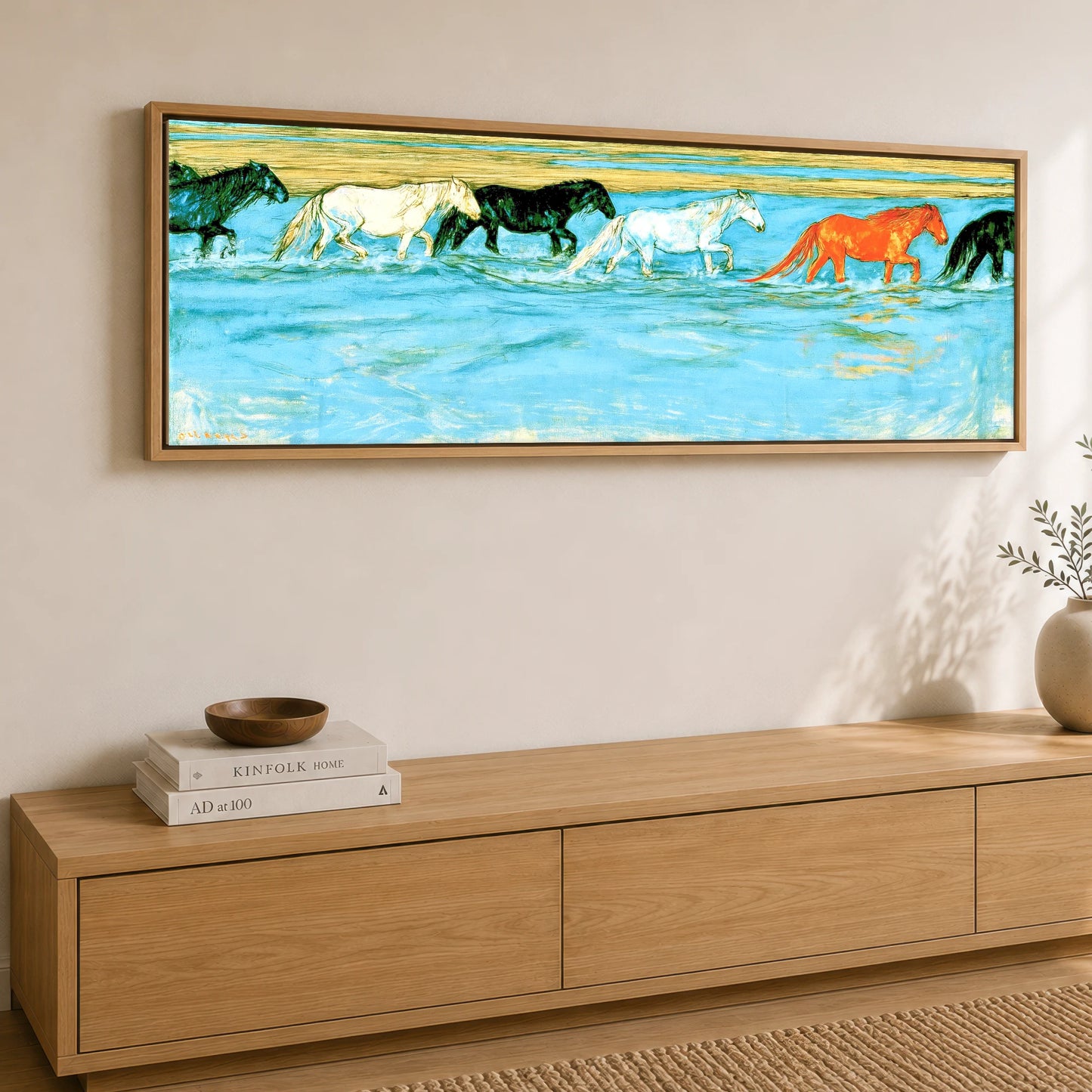 Painted Herd in Azure Horse Landscape panoramic canvas wall art displayed above a sideboard