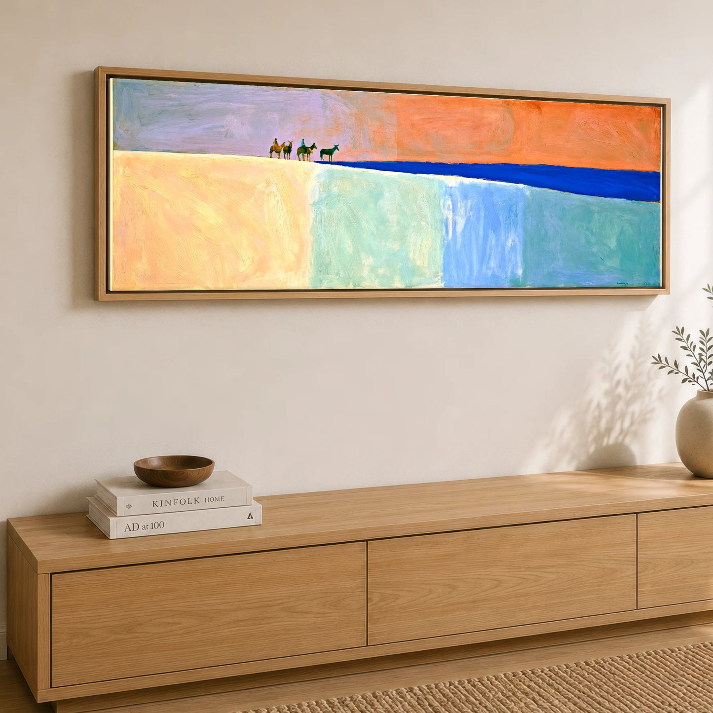 The Cobalt Horizon Horse & Rider panoramic canvas wall art displayed above a sideboard