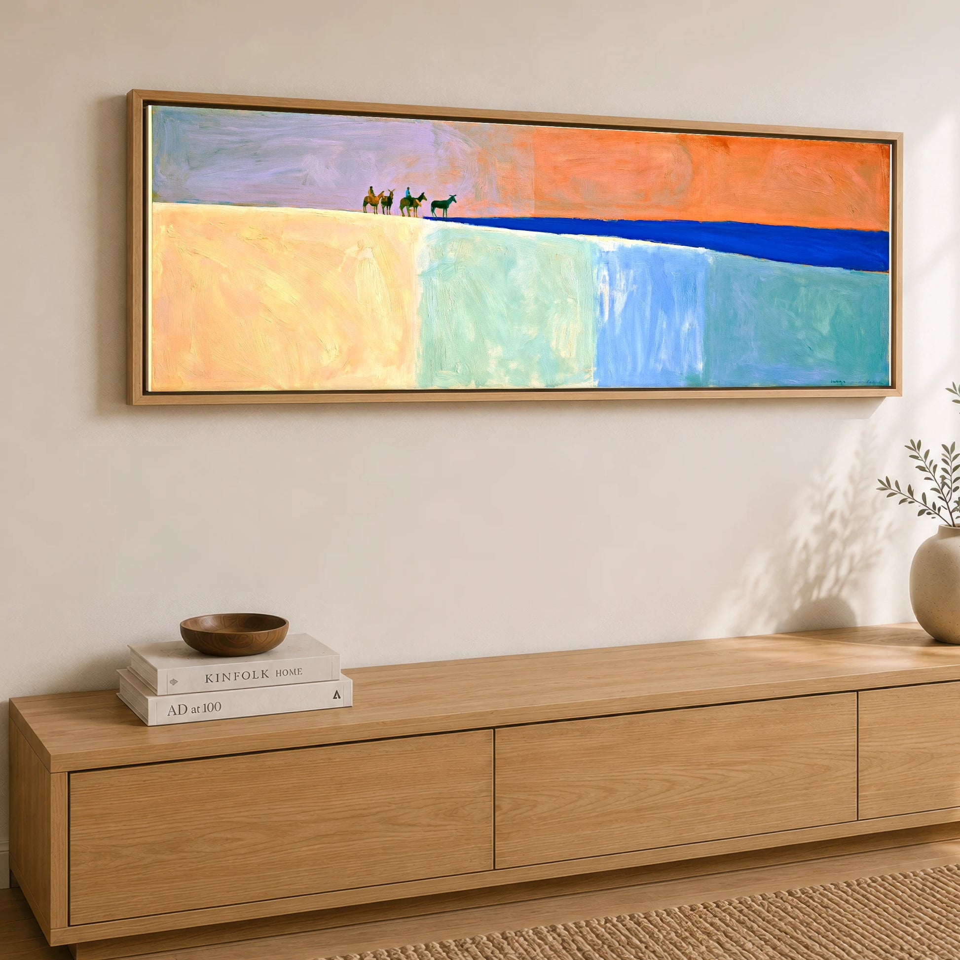 The Cobalt Horizon Horse & Rider panoramic canvas wall art displayed above a sideboard