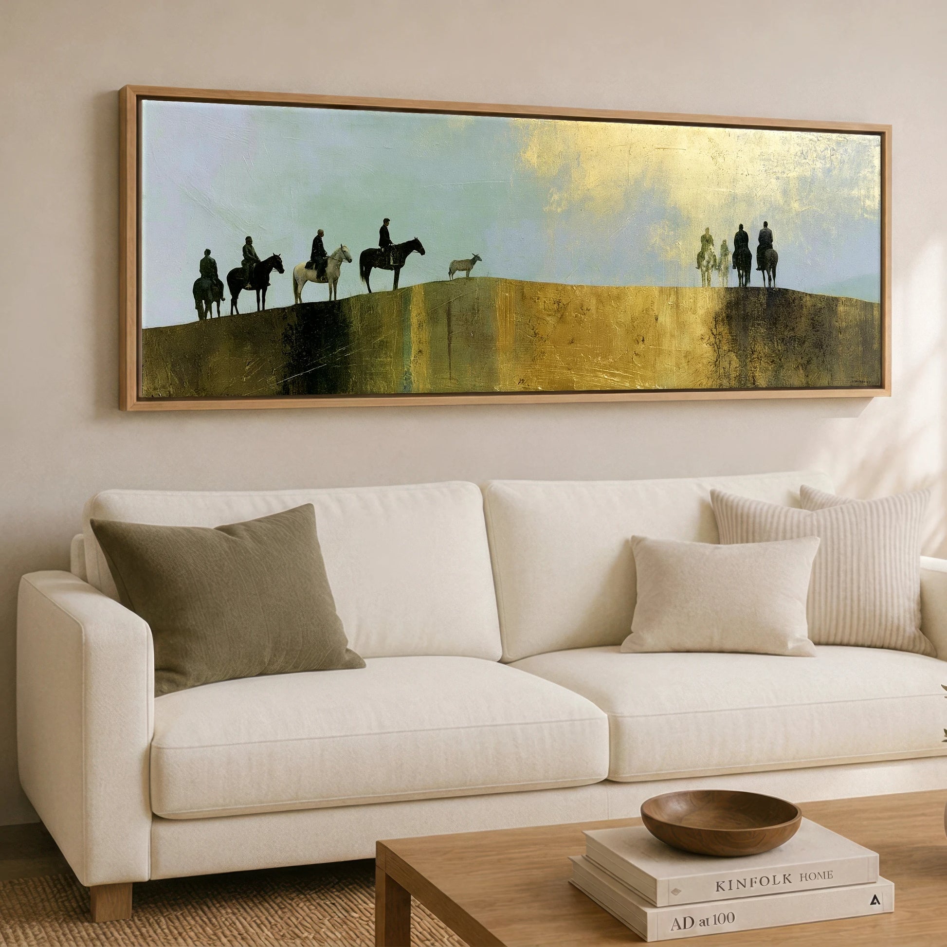 The Golden Ridge Horse & Rider panoramic canvas wall art displayed above a sofa