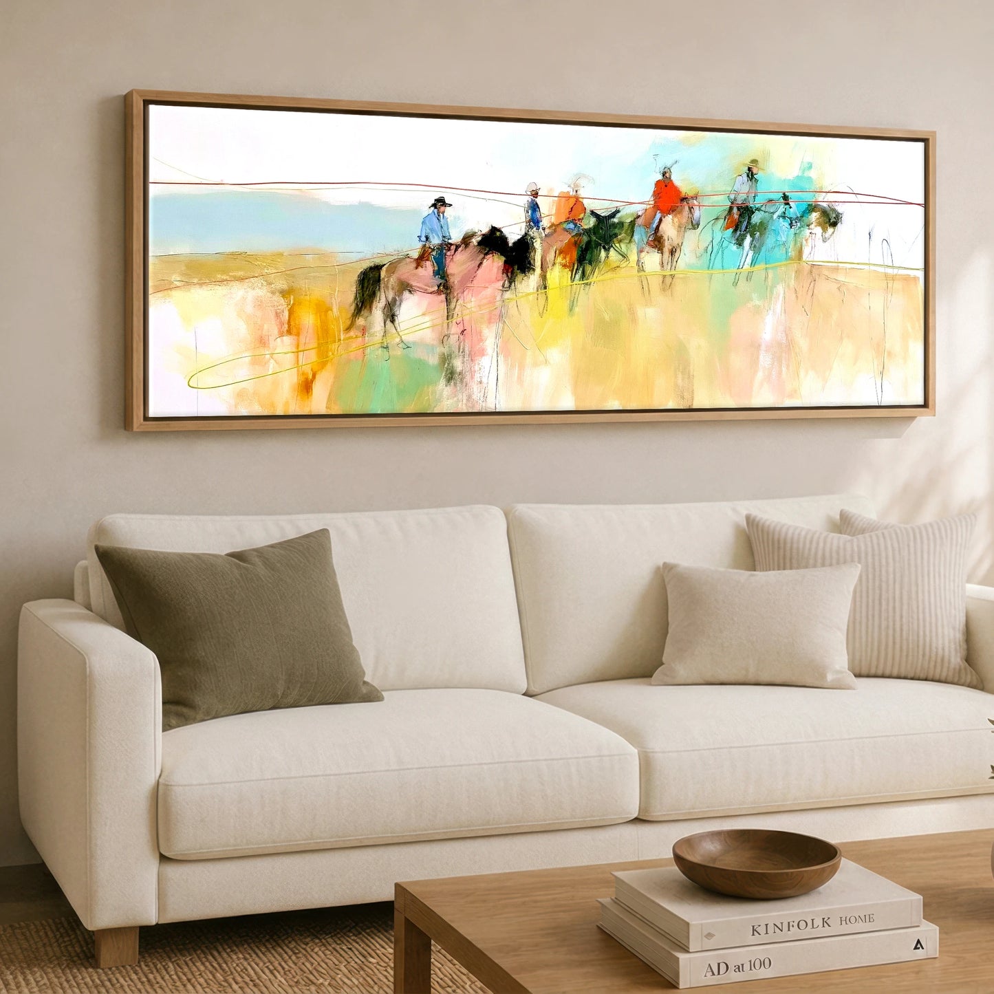 Across the High Plains Horse & Rider panoramic canvas wall art displayed above a sofa