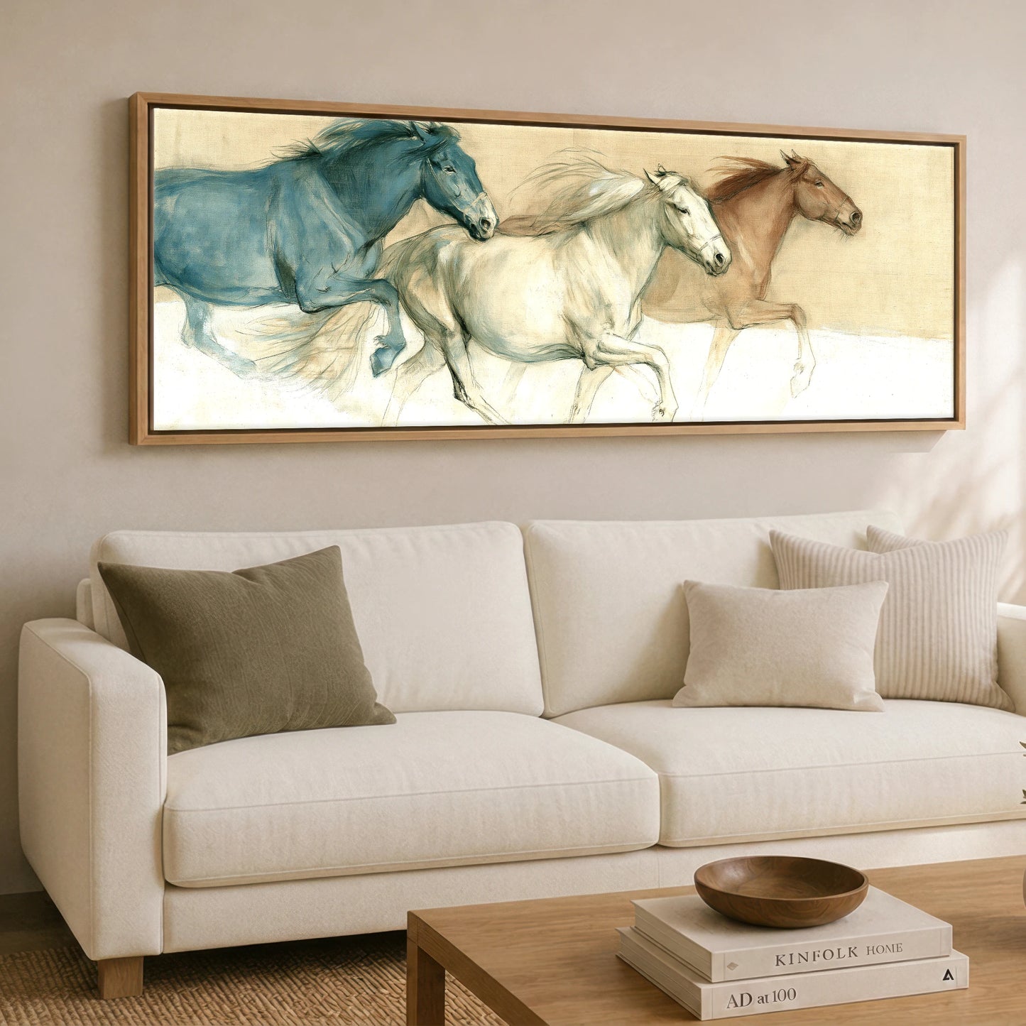 The Three Strides Horse Landscape panoramic canvas wall art displayed above a sofa