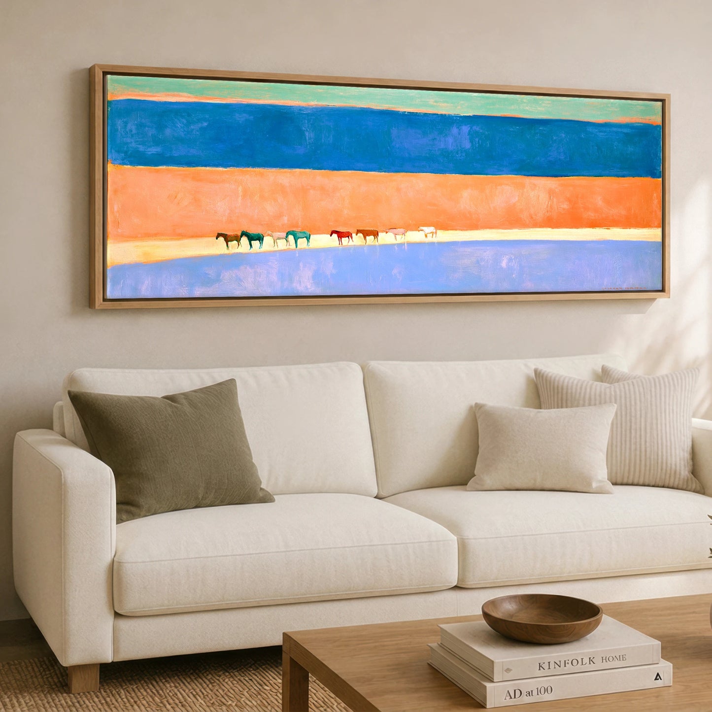 The Painted Horizon Wild Horses panoramic canvas wall art displayed above a sofa