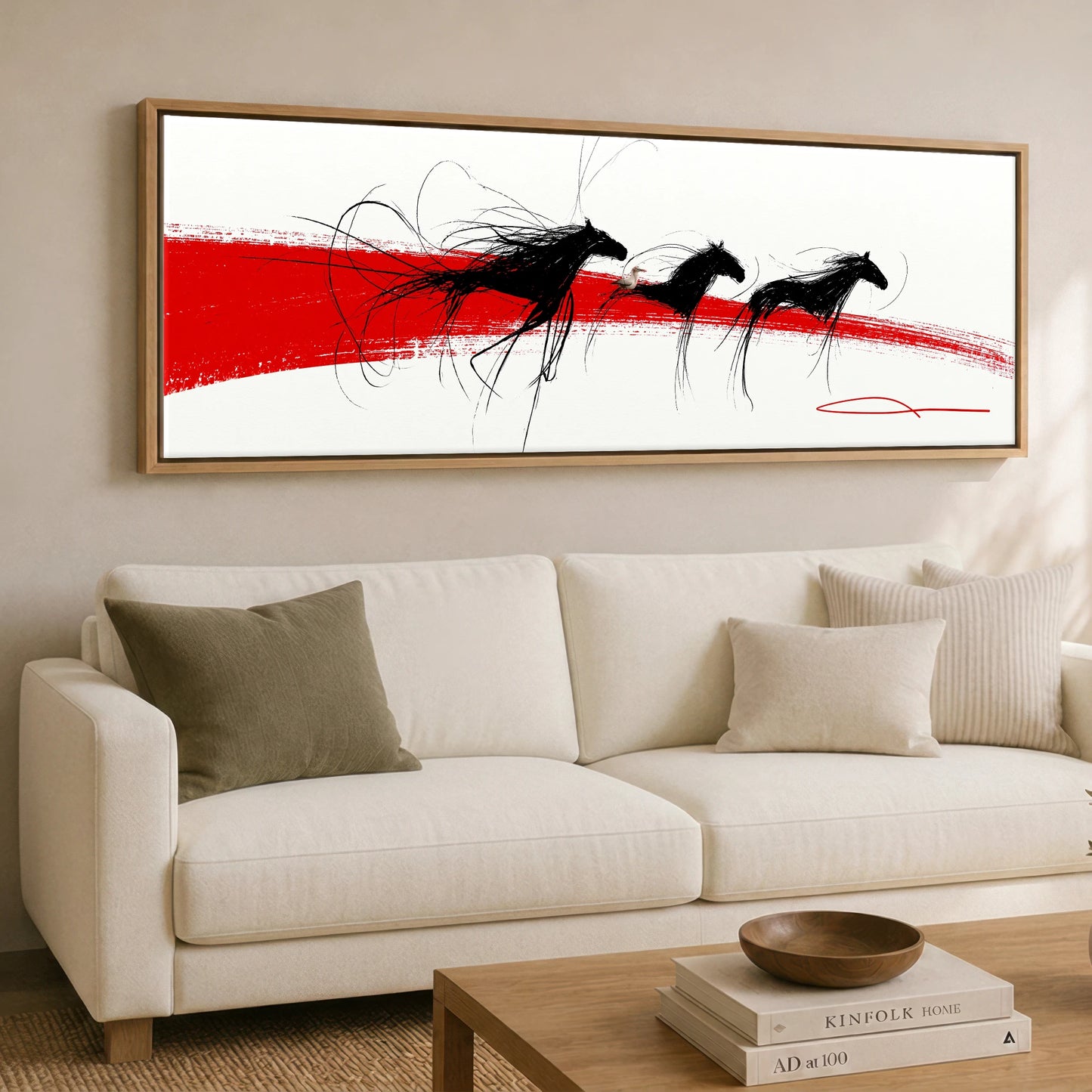The Crimson Gallop Wild Horses panoramic canvas wall art displayed above a sofa