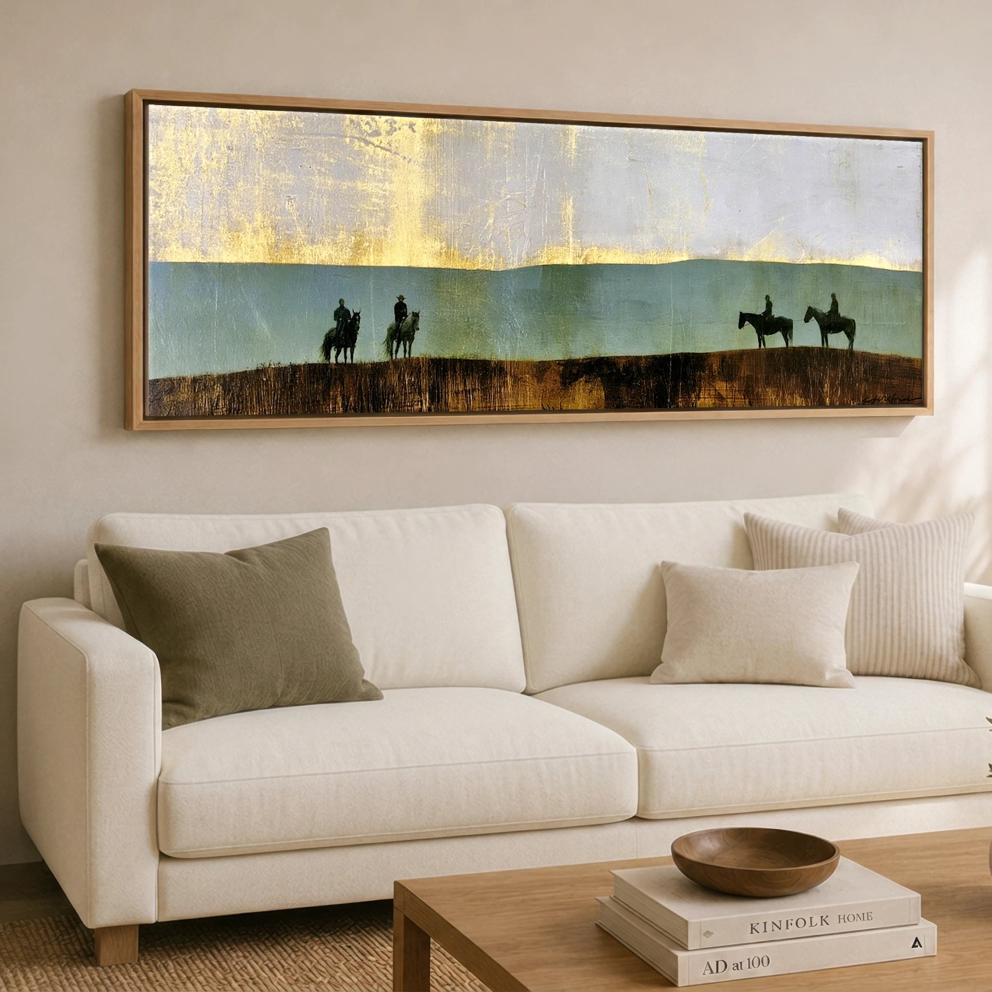 The Gilded Ridge Horse & Rider panoramic canvas wall art displayed above a sofa