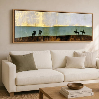 The Gilded Ridge Horse & Rider panoramic canvas wall art displayed above a sofa