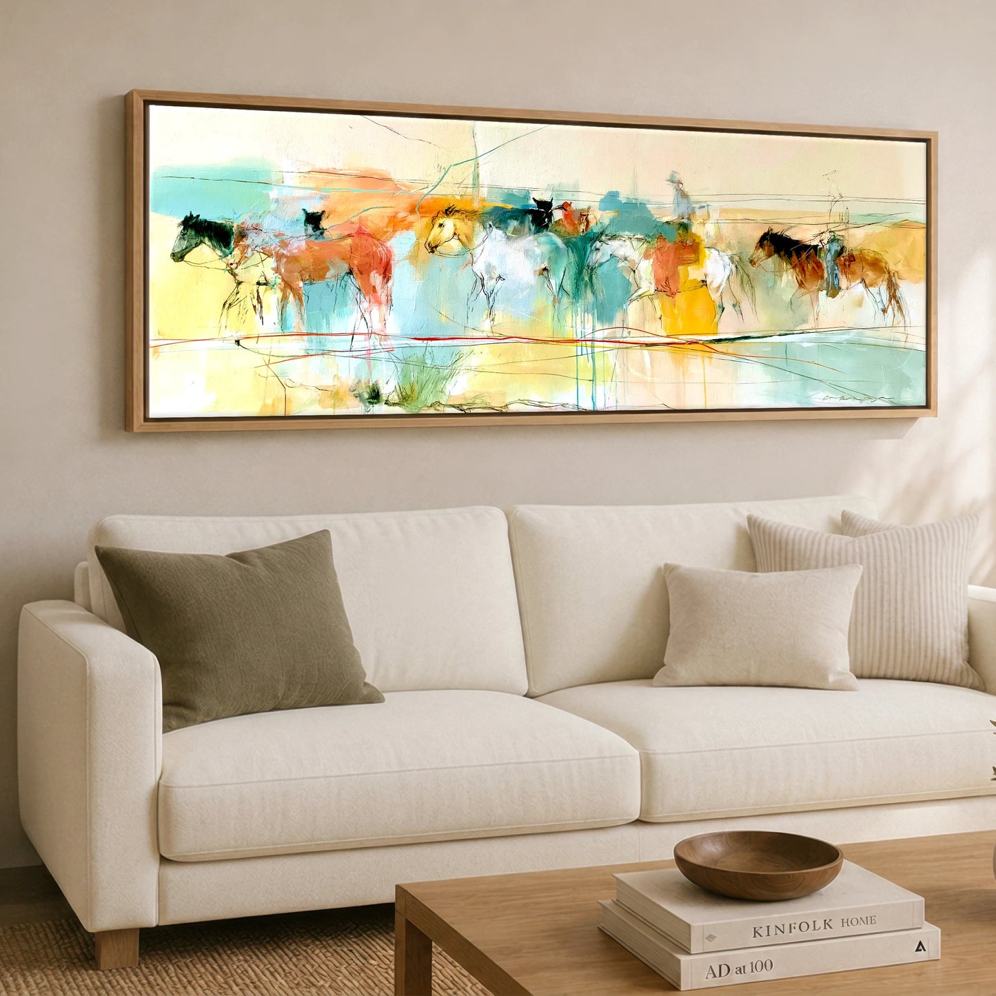 The Painted Trail Horse Landscape panoramic canvas wall art displayed above a sofa