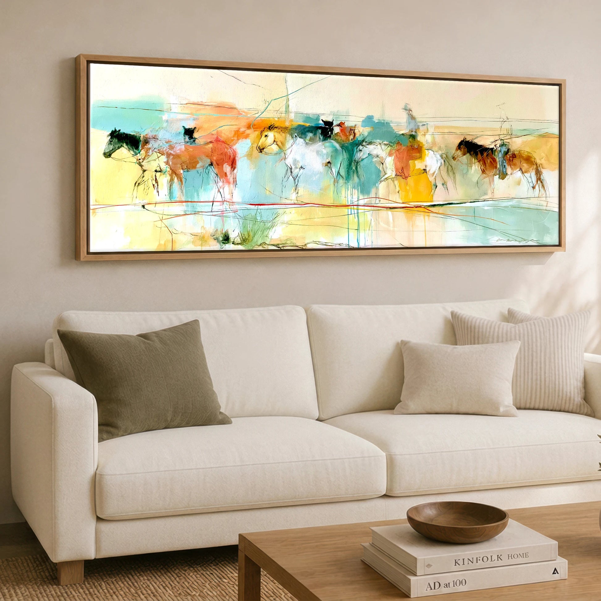The Painted Trail Horse Landscape panoramic canvas wall art displayed above a sofa