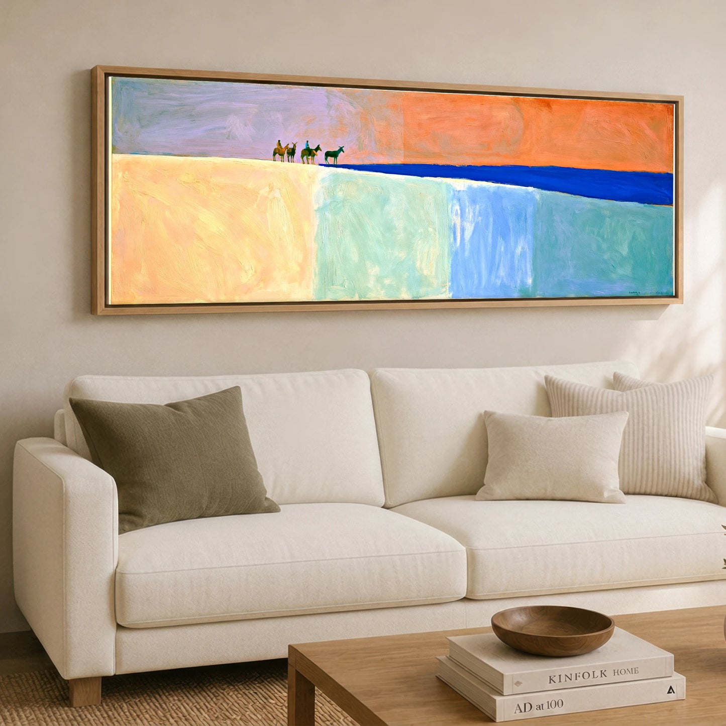 The Cobalt Horizon Horse & Rider panoramic canvas wall art displayed above a sofa
