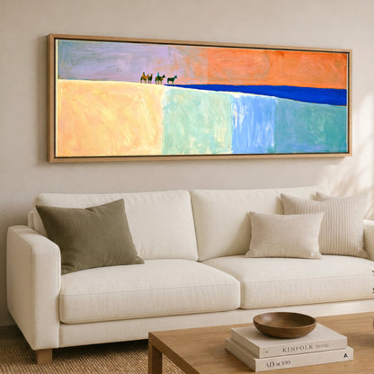 The Cobalt Horizon Horse & Rider panoramic canvas wall art displayed above a sofa