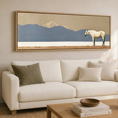 The Quiet Expanse Horse Landscape panoramic canvas wall art displayed above a sofa