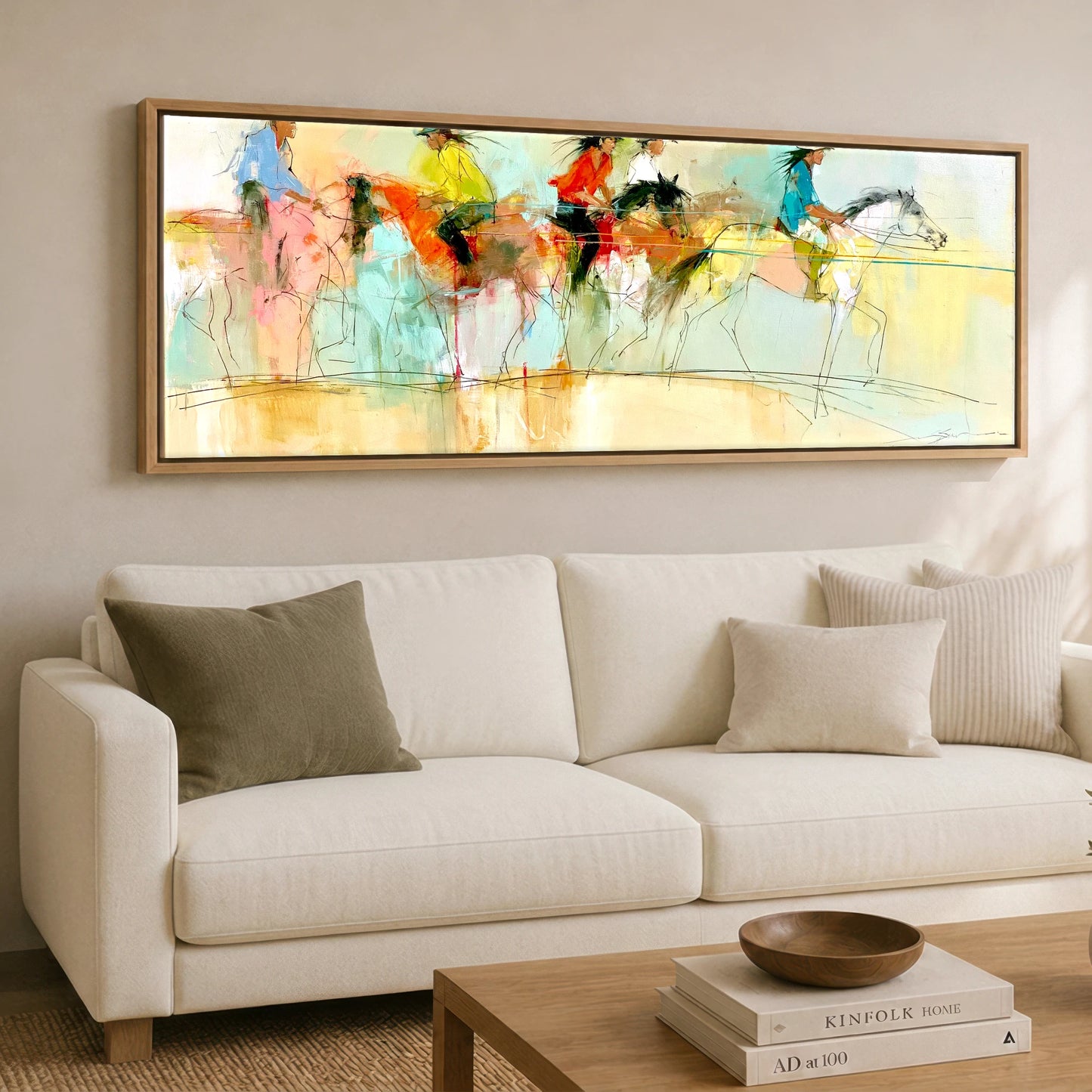 The Vibrant Canter Horse & Rider panoramic canvas wall art displayed above a sofa