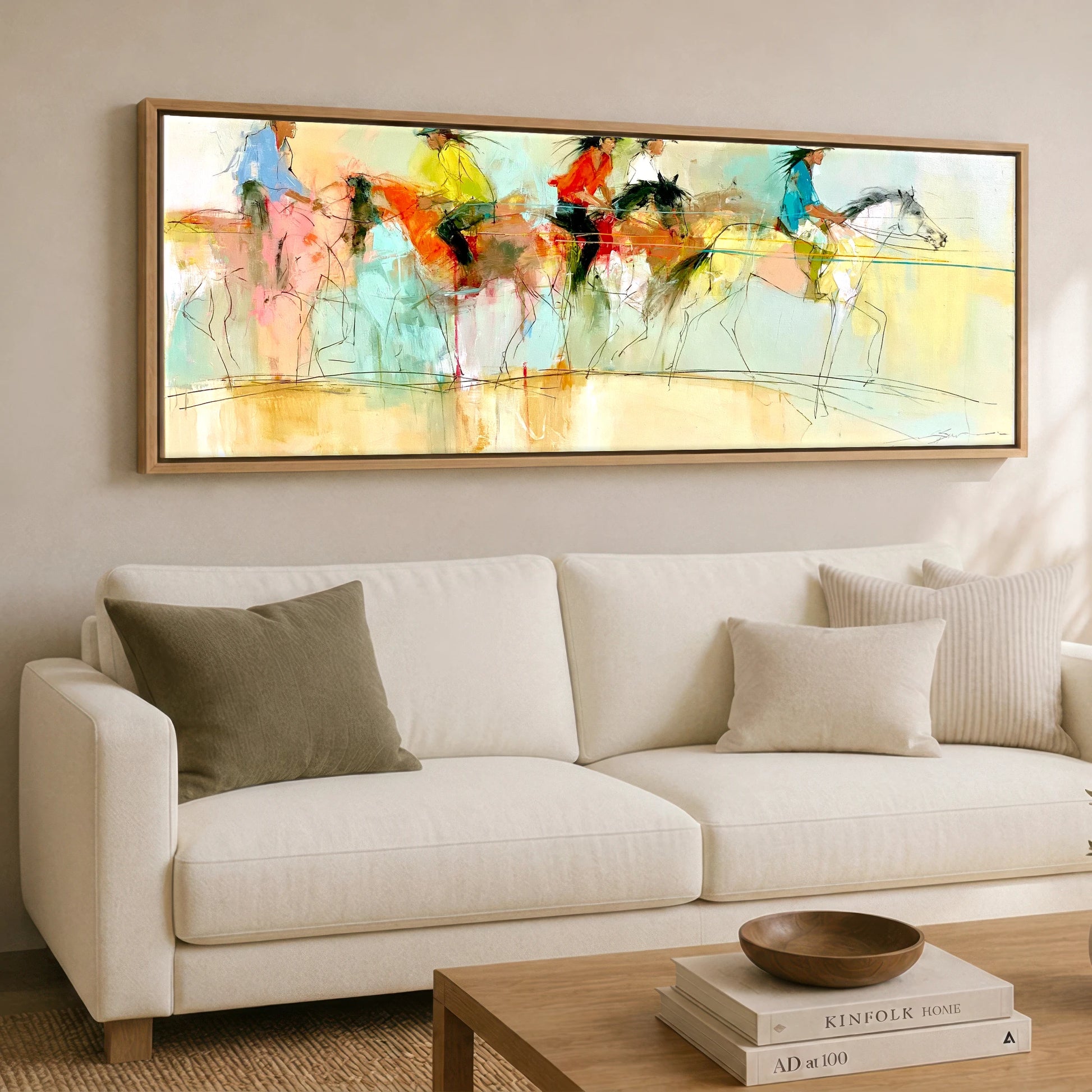 The Vibrant Canter Horse & Rider panoramic canvas wall art displayed above a sofa