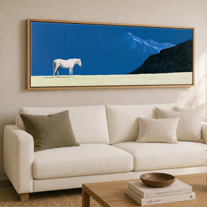 Solitude in Blue Horse Landscape panoramic canvas wall art displayed above a sofa